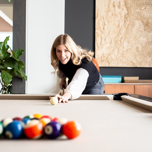 woman about to break a rack of pool balls