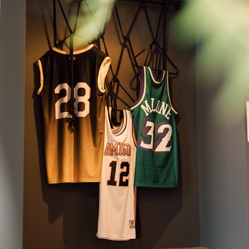 three basketball jerseys hanging as decoration in the game lounge