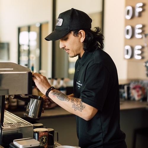 barista making a drink at the onsite coffee shop