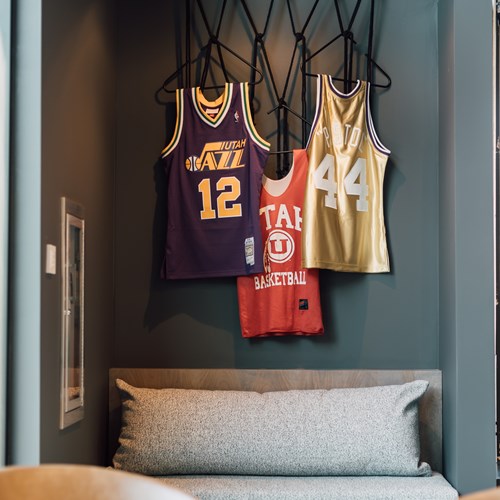 three Utah jerseys hanging in the game lounge